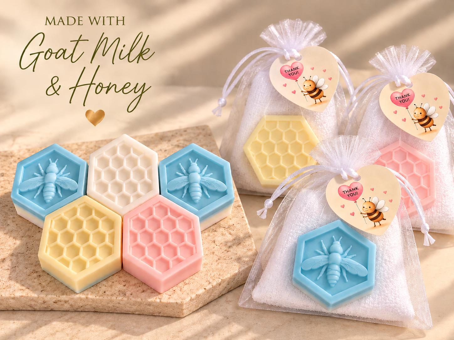 Pastel hexagonal goat milk and honey soaps with bee and honeycomb designs, displayed beside gift bags with soft face towels