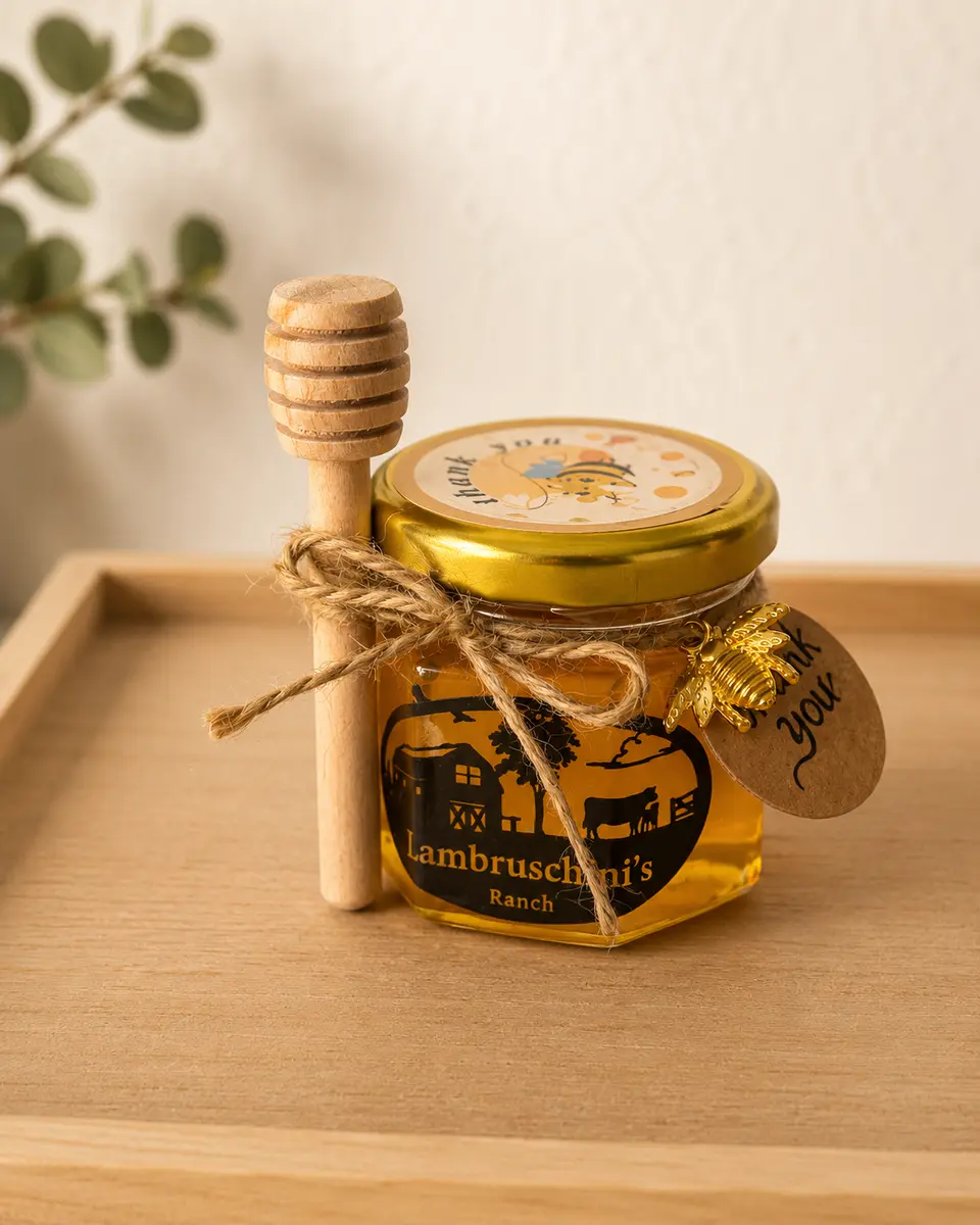 Small 1.5 oz jar of Orange Blossom Raw Honey with a wooden honey dipper