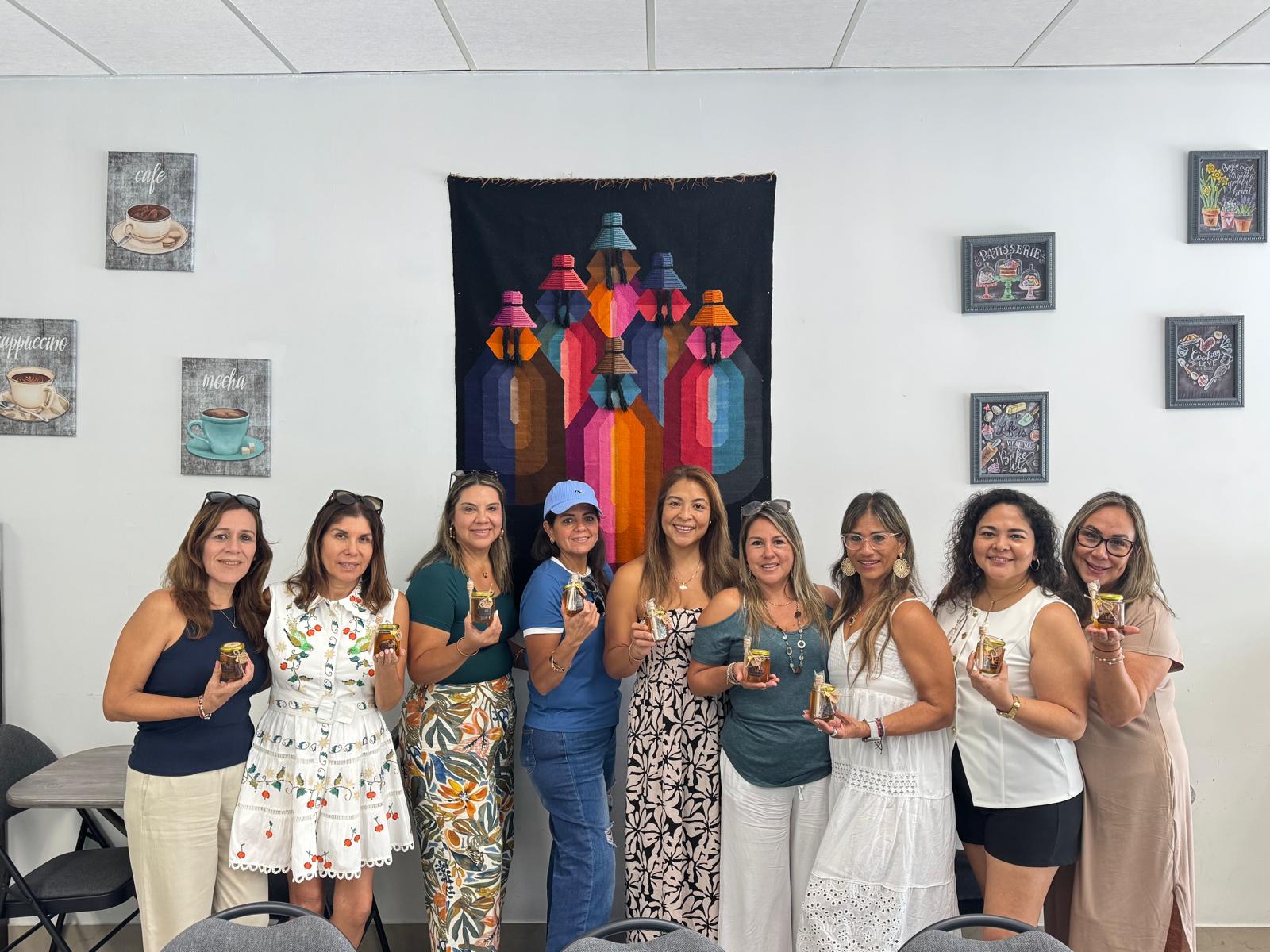 A group of happy Bee Wellness customers holding jars of Lambruschini’s Ranch honey